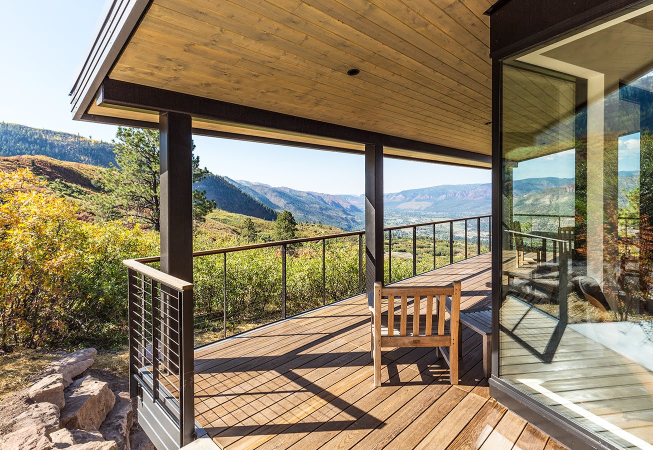 Edmonds House.Wooden terrace with a roof and a beautiful view of green nature.