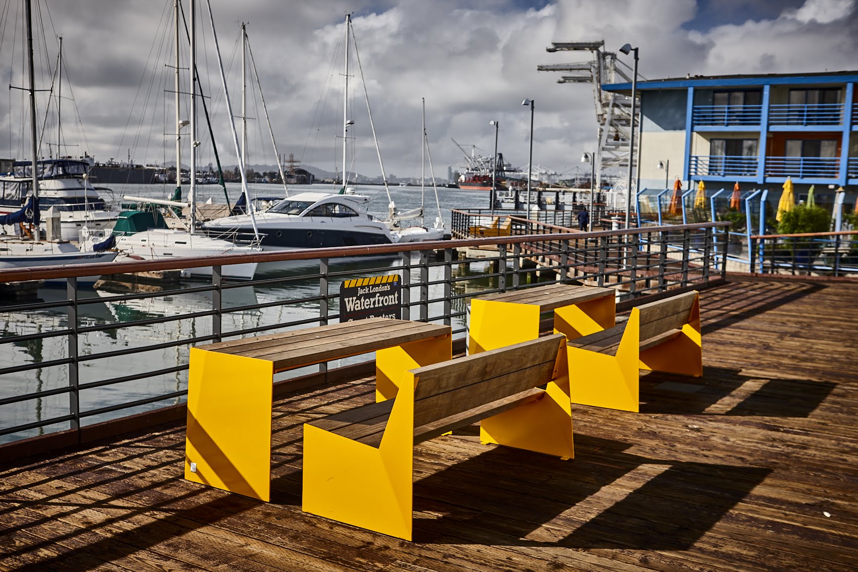 Sunbenches and chairs in waterfront area.
